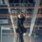 Worker Installing led batten lights in supermarkets.